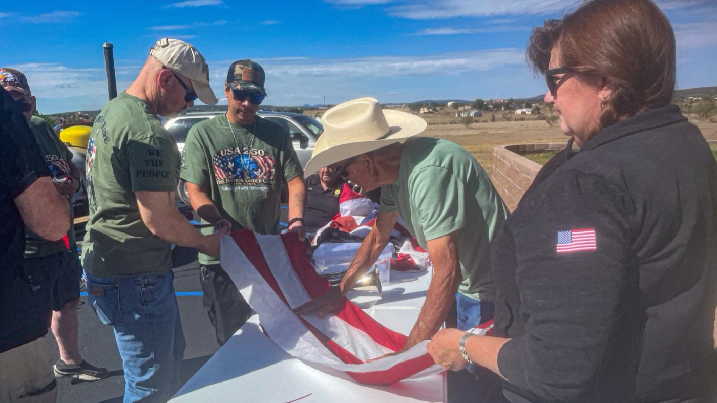 Veterans folding a worn American flag for retirement